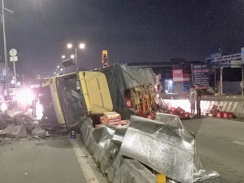 Xe tải lật ngang, hàng trăm thùng bia, nước ngọt đổ đầy đường